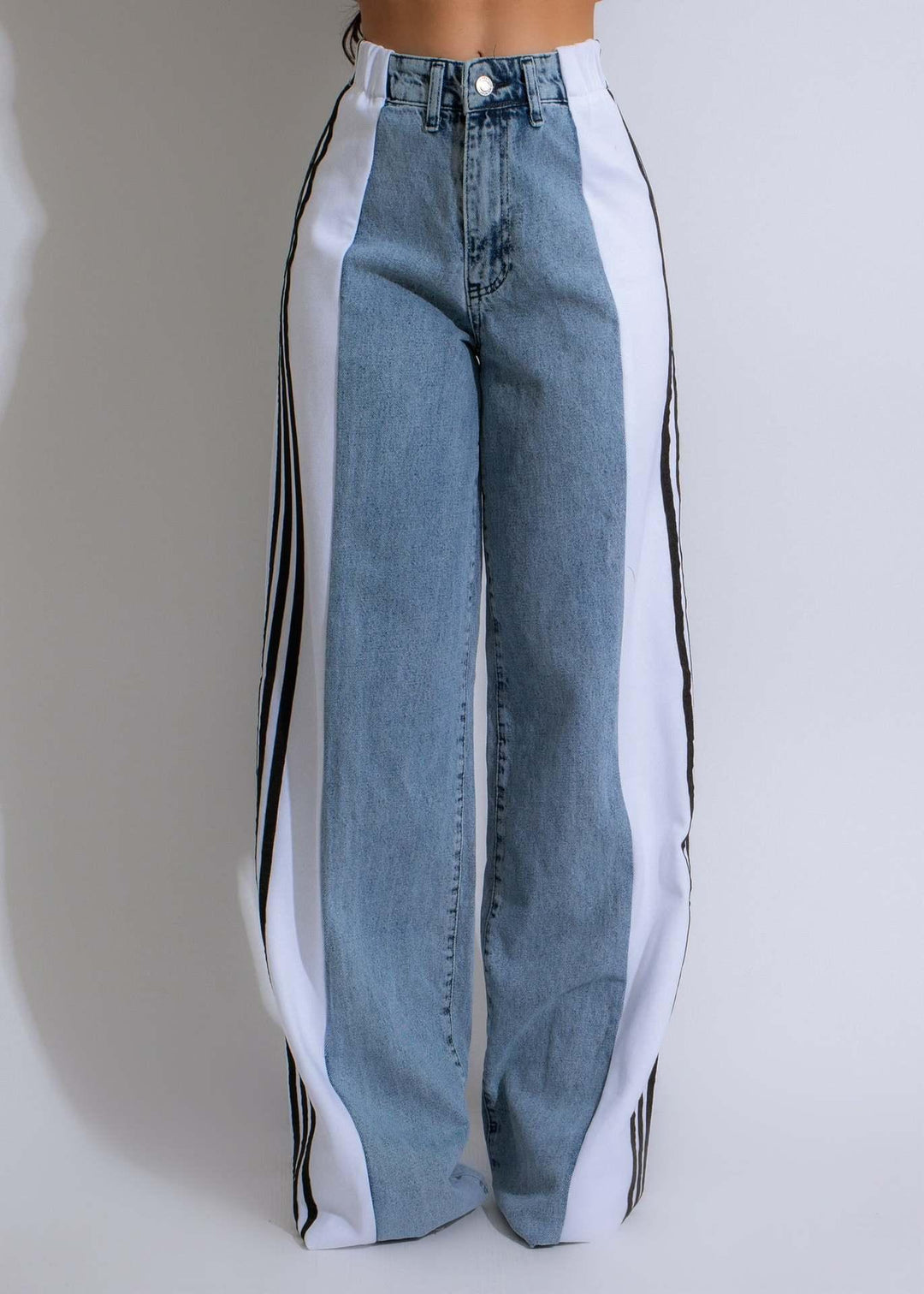 High-waisted wide-leg jeans with blue denim center and white side panels featuring black stripes