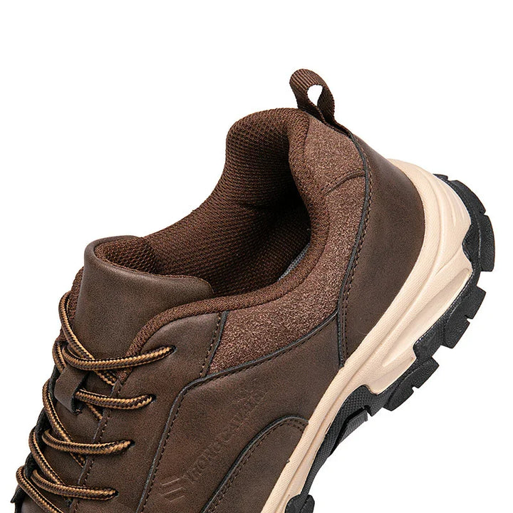 Brown hiking shoe with padded collar, textured laces, and rugged beige sole on white background