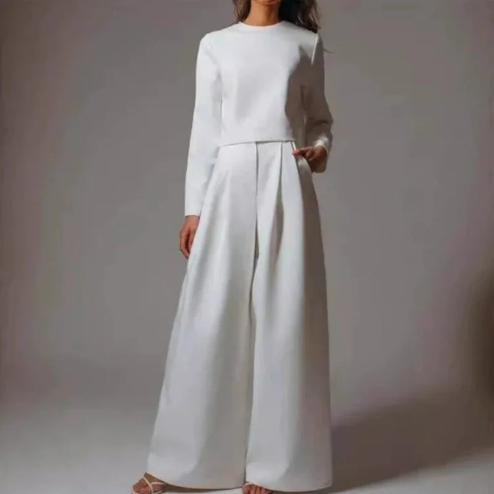 Woman wearing a white long-sleeve crop top and wide-leg high-waisted pants fashion outfit