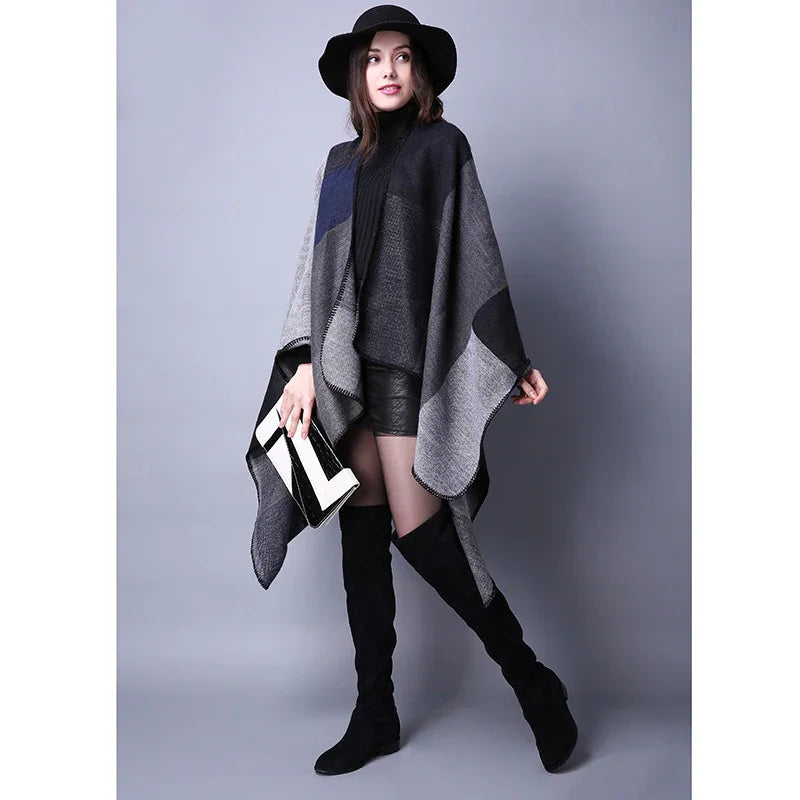 Woman wearing black hat, gray and black poncho, black shorts, thigh-high boots, holding black and white clutch