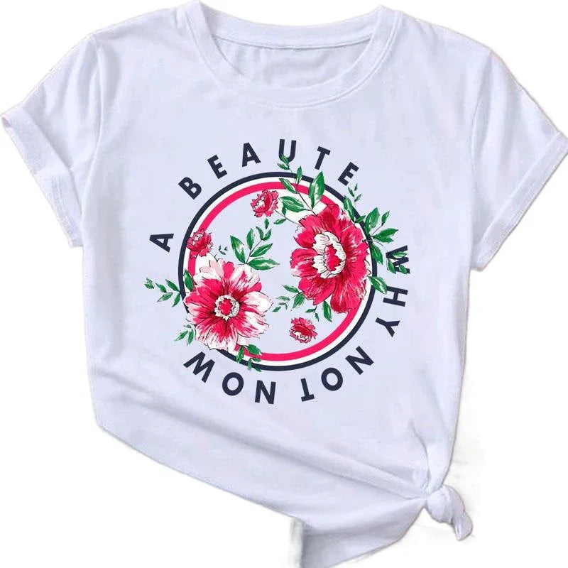 White t-shirt with red and pink floral design and text circle reading "A Beaute Why Not Now"