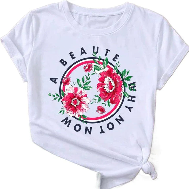 White t-shirt with red and pink floral design and text circle reading "A Beaute Why Not Now"