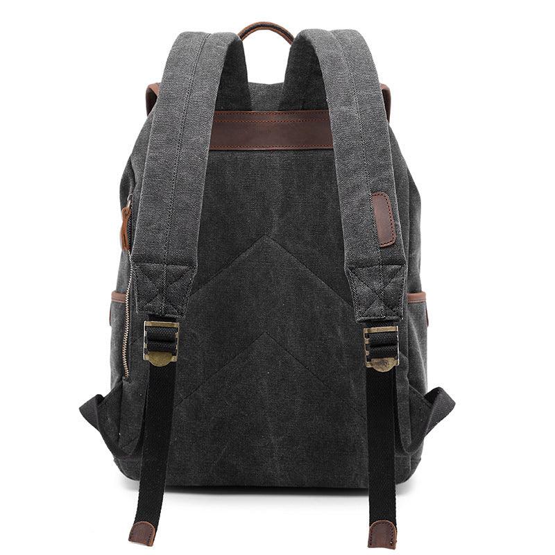 Dark gray canvas backpack with padded straps, leather accents, and adjustable black buckles shown from back