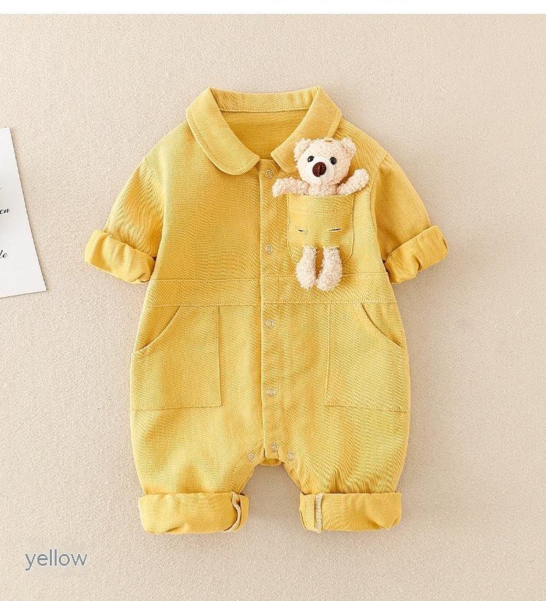 Yellow baby romper with rolled sleeves and legs, featuring a front pocket holding a small teddy bear