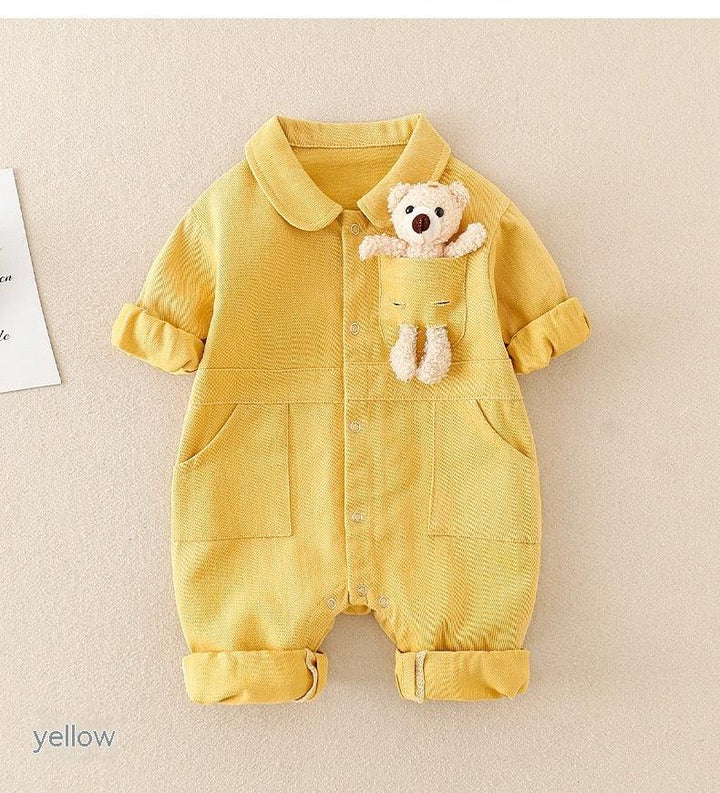 Yellow baby romper with rolled sleeves and legs, featuring a front pocket holding a small teddy bear