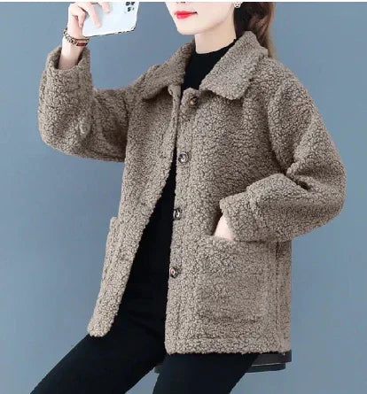 Woman wearing cozy brown sherpa fleece jacket with buttons and large front pockets