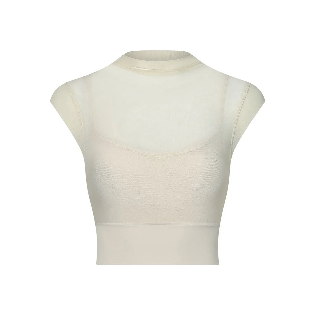 Beige seamless crop top with cap sleeves and high neckline on white background
