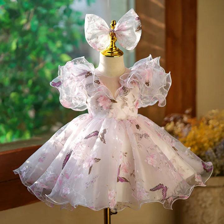 Elegant baby girl dress with floral and butterfly prints, puff sleeves, and matching bow headband