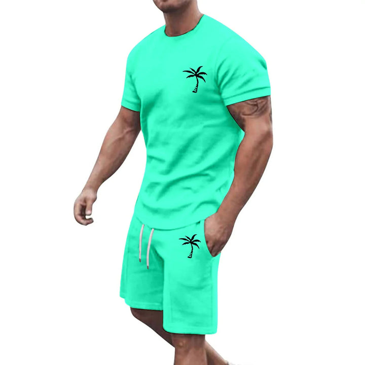 Muscular man wearing turquoise matching t-shirt and shorts set with black palm tree print