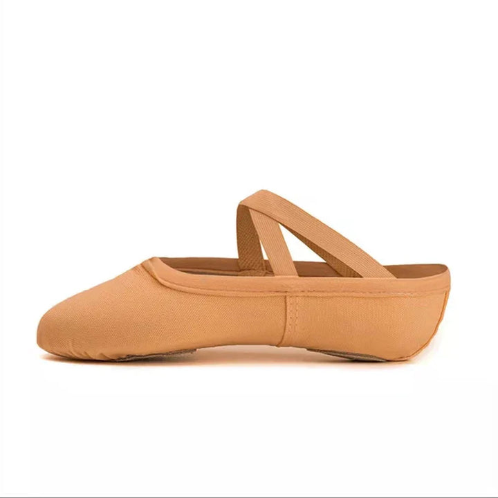 Tan canvas ballet slipper with elastic cross straps, side view on white background
