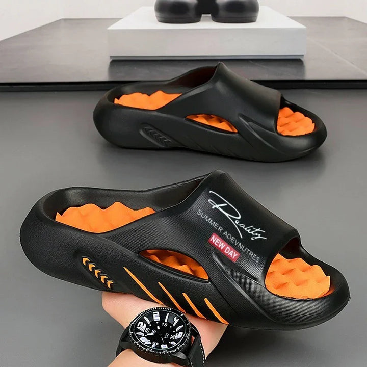 black and orange slide sandals with cushioned sole and text 'Reality Summer Adventures New Day' on strap
