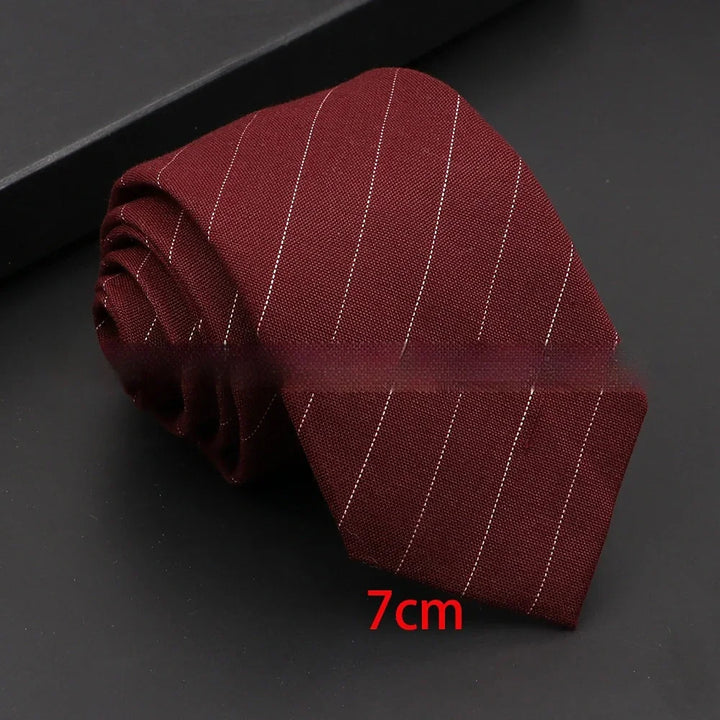 Rolled burgundy necktie with thin white stripes on black background, 7cm width