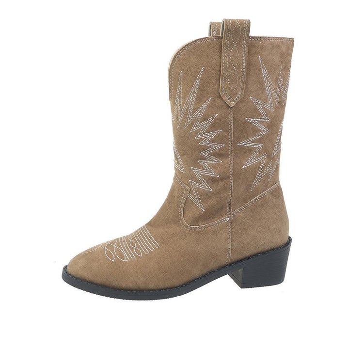 Tan suede Western cowboy boot with white zigzag stitching and low stacked heel