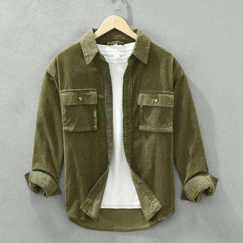 Olive green corduroy shirt jacket with buttoned flap pockets over white t-shirt on hanger