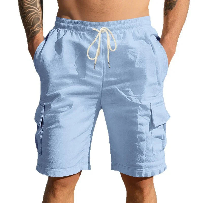 Men's light blue cargo shorts with drawstring waist and side pockets on tattooed model