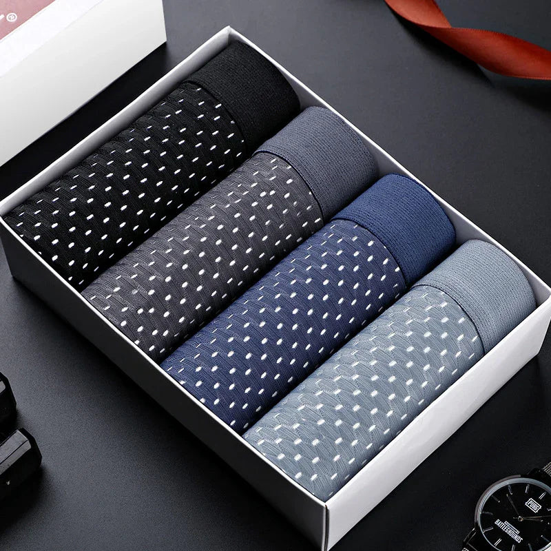 Box of four men's rolled cotton polka dot socks in black, gray, navy, and light blue colors