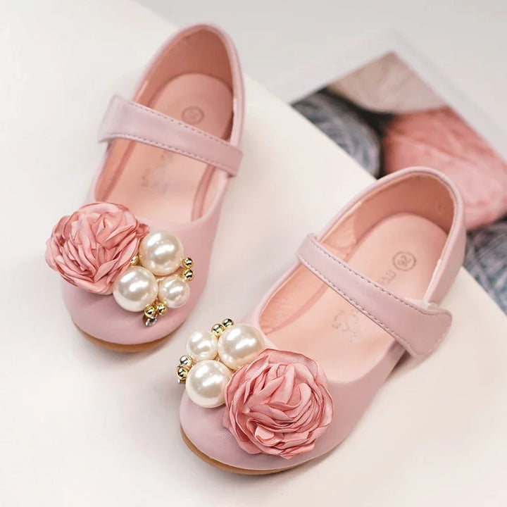 Pink baby girl shoes with strap, decorated with fabric flowers and pearl embellishments