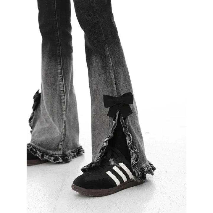 Black and white faded flared jeans with ruffled hems and bow detail paired with black Adidas sneakers