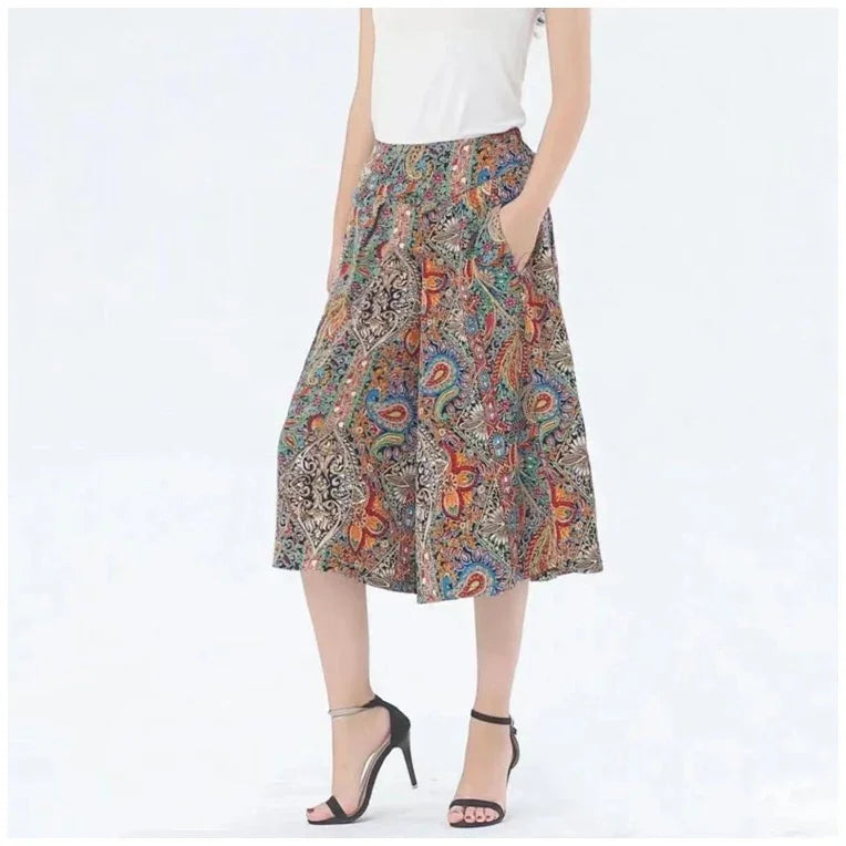 woman wearing colorful paisley print wide leg cropped pants with pockets and black high-heeled sandals