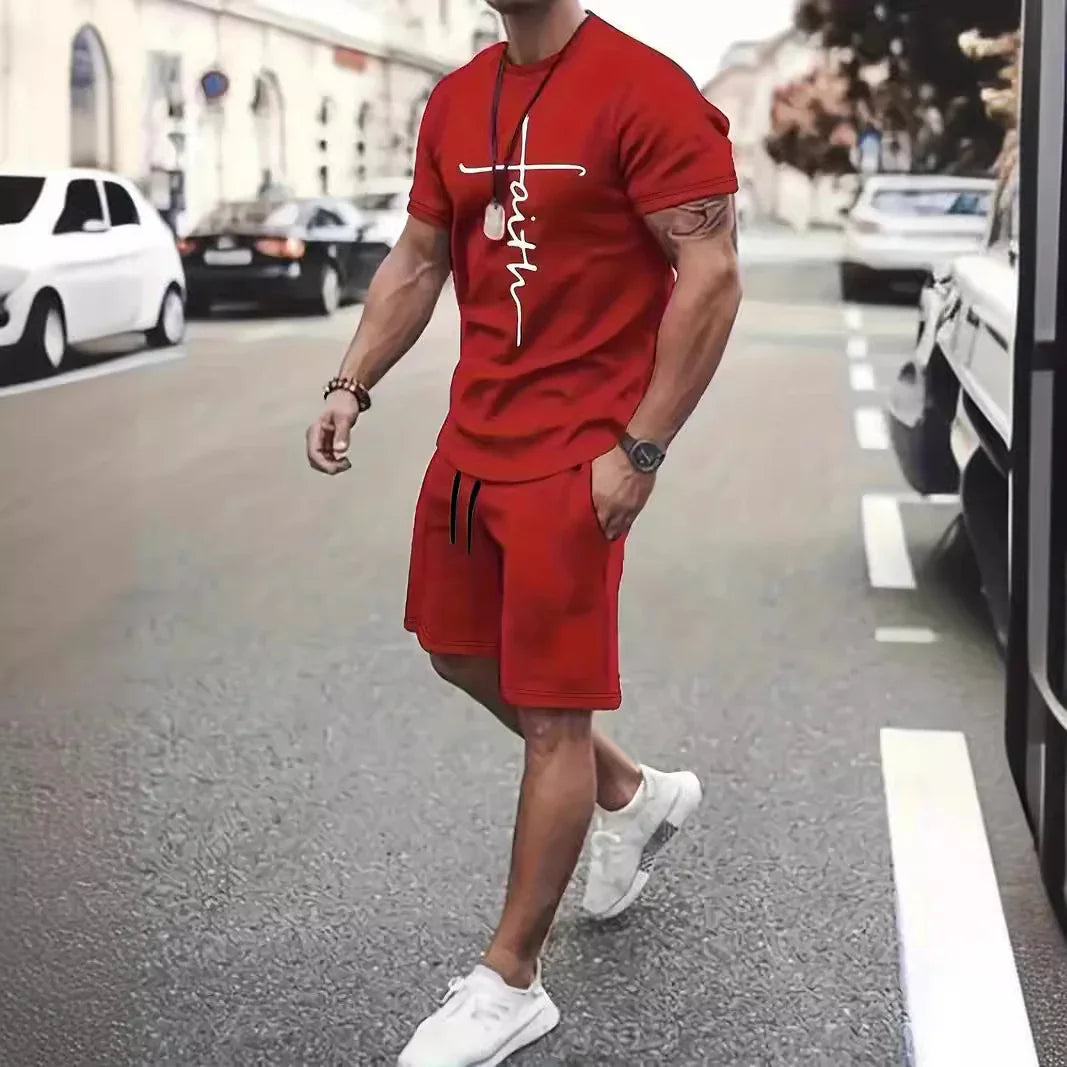 Man in red faith graphic t-shirt and matching shorts walking on city street with white sneakers