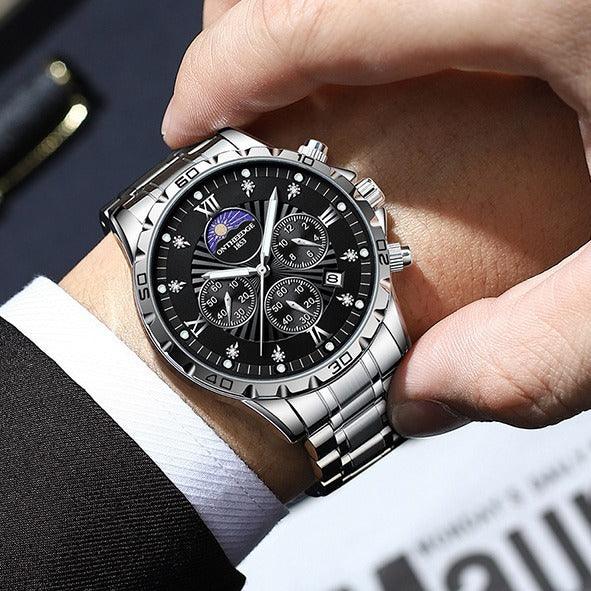 close-up of luxury stainless steel men's wristwatch with black dial and chronograph on wrist