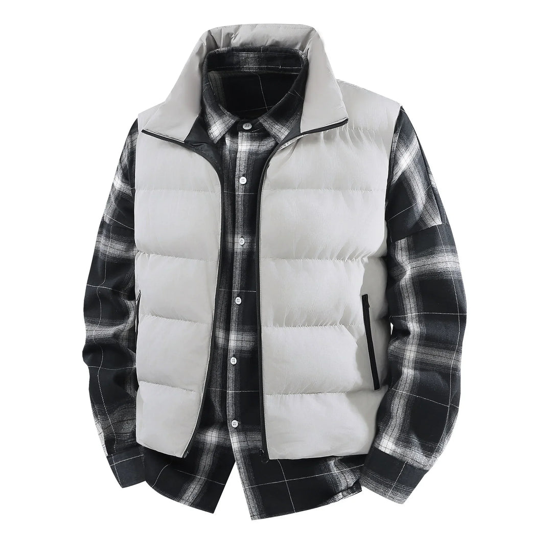 Light gray puffer vest layered over black and white plaid flannel shirt on white background