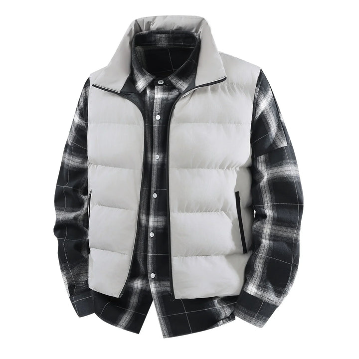Light gray puffer vest layered over black and white plaid flannel shirt on white background