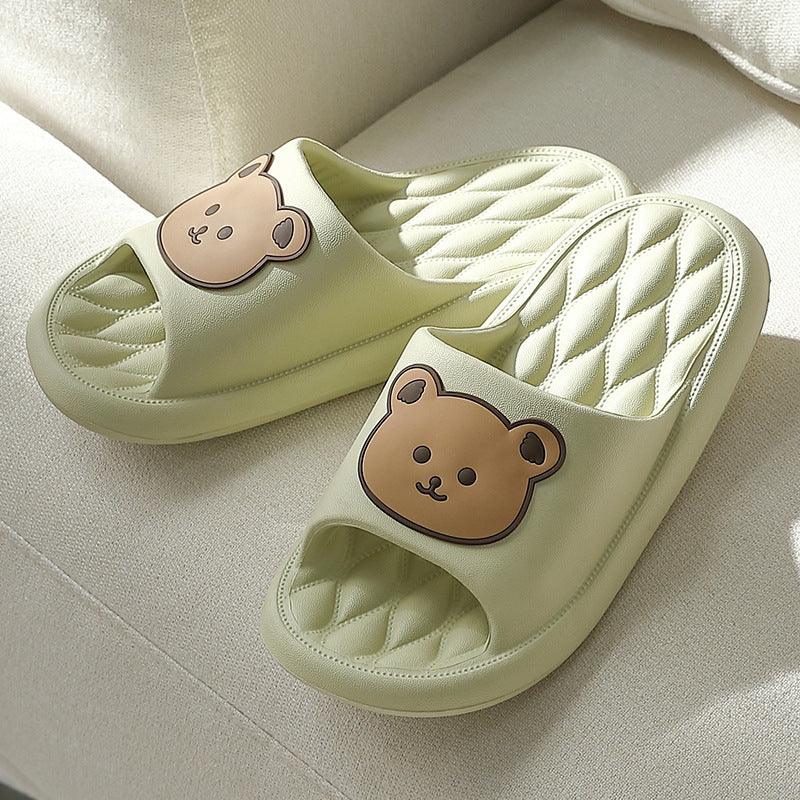 Light green cushioned slippers with quilted insoles and cute brown bear face design on top