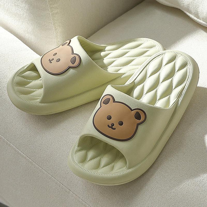 Light green cushioned slippers with quilted insoles and cute brown bear face design on top