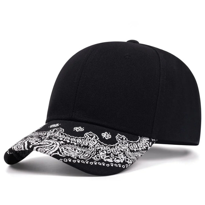 Black baseball cap with curved brim featuring white paisley bandana print