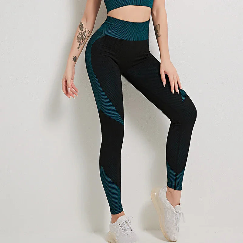 Woman wearing black and teal high-waisted leggings and matching crop top with white sneakers