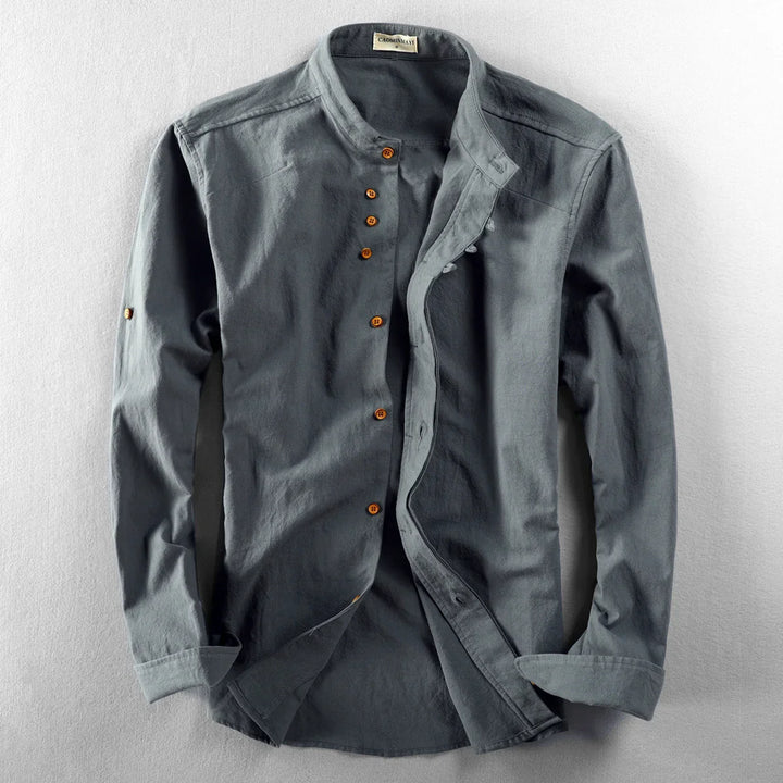 Gray long-sleeve men's shirt with wooden buttons and mandarin collar laid flat on white surface