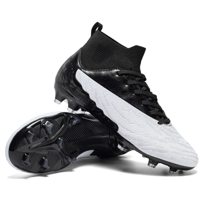 Black and white soccer cleats with high ankle collar and textured sole studs on white background