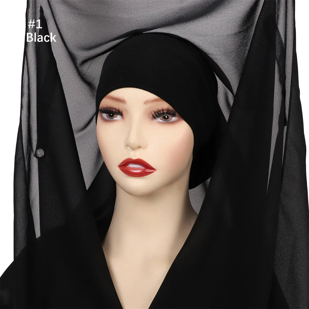 Mannequin with black inner hijab cap and sheer black veil fabric backdrop