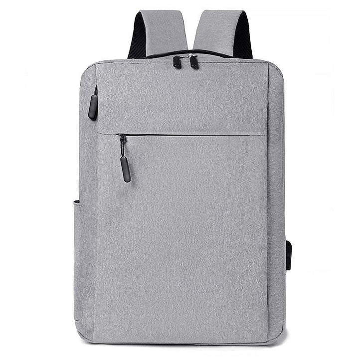Modern gray backpack with front zipper pocket and padded shoulder straps on white background