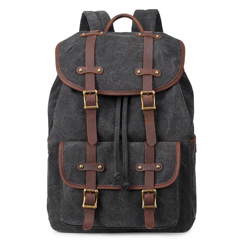 Dark gray canvas backpack with brown leather straps and front pocket, vintage style travel bag
