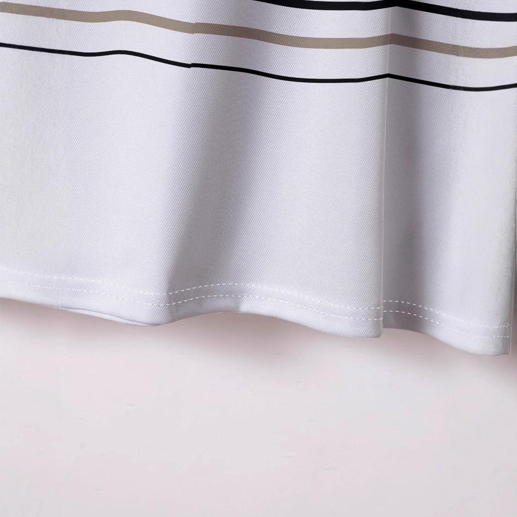 Close-up of white textured fabric with beige and black horizontal stripes and stitched hem