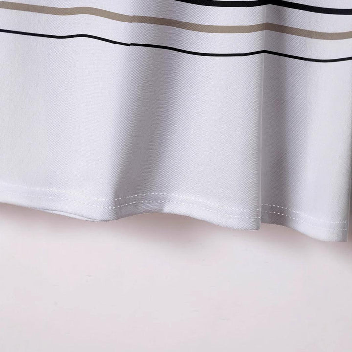 Close-up of white textured fabric with beige and black horizontal stripes and stitched hem