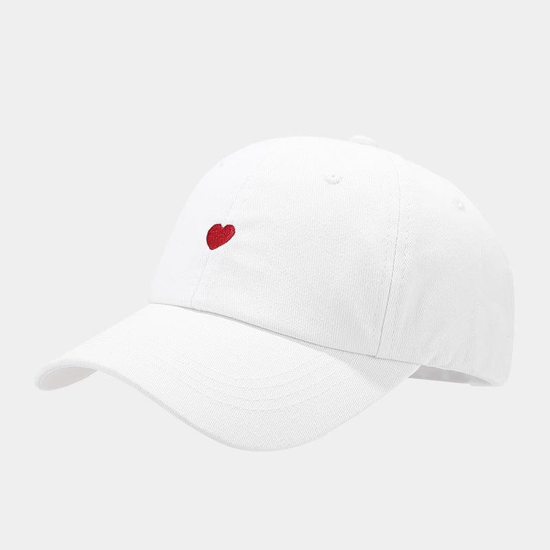White baseball cap with small red heart embroidered on front