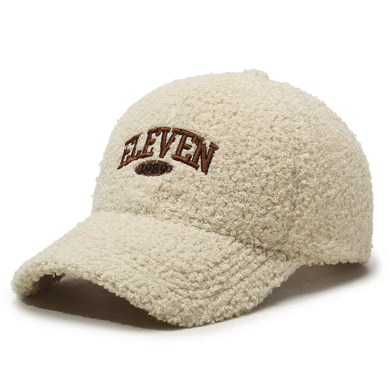 Cream sherpa textured baseball cap with brown embroidered ELEVEN logo on front