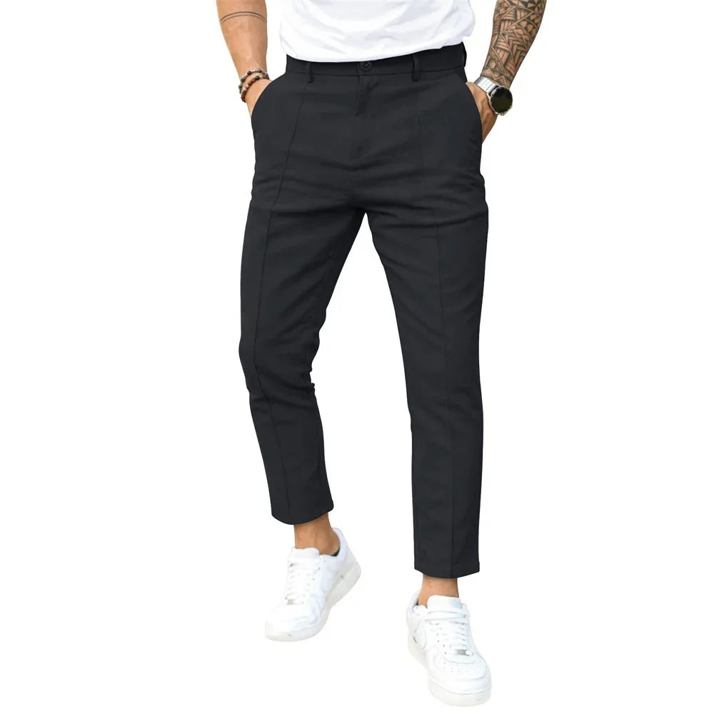 Man wearing slim-fit black cropped pants with white sneakers and a white t-shirt