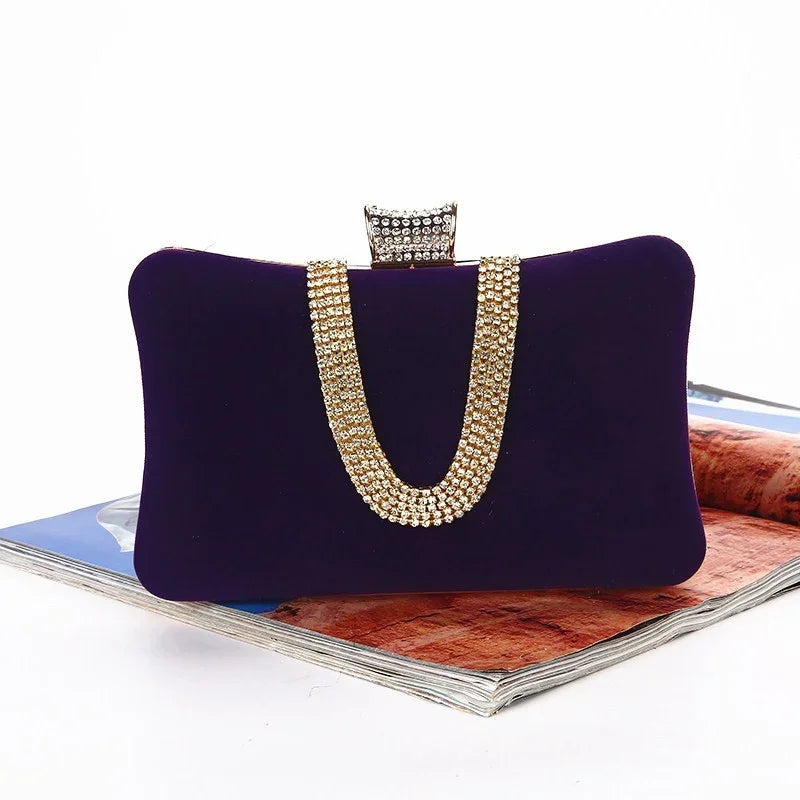 Elegant purple velvet clutch bag with gold rhinestone chain and jeweled clasp on magazine