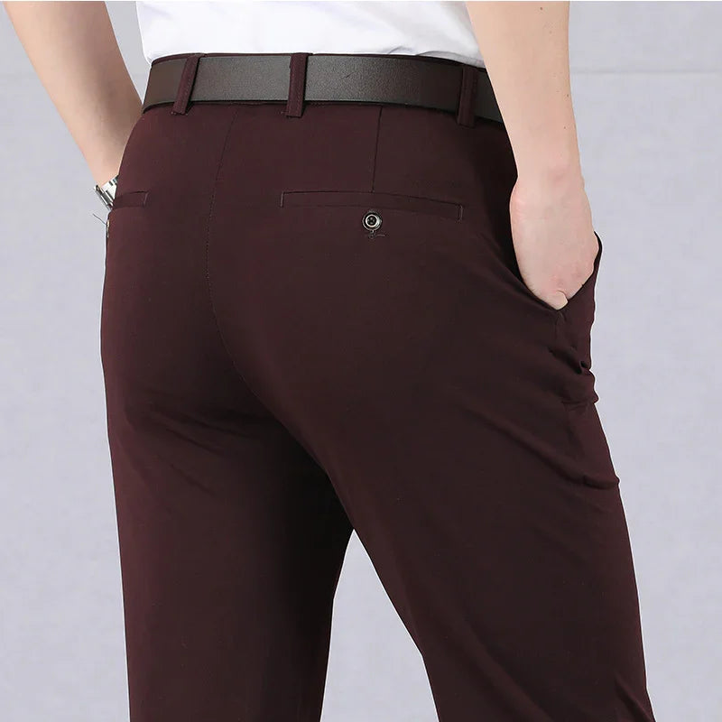 Man wearing dark brown formal trousers with back button pocket and brown leather belt