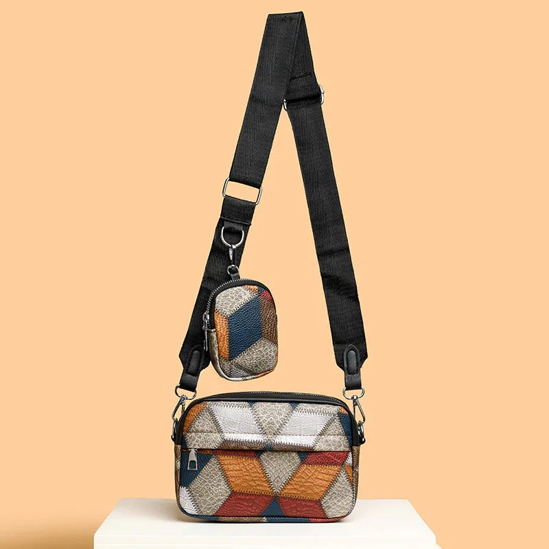 Adjustable black strap crossbody bag with geometric patterned main pouch and small pouch