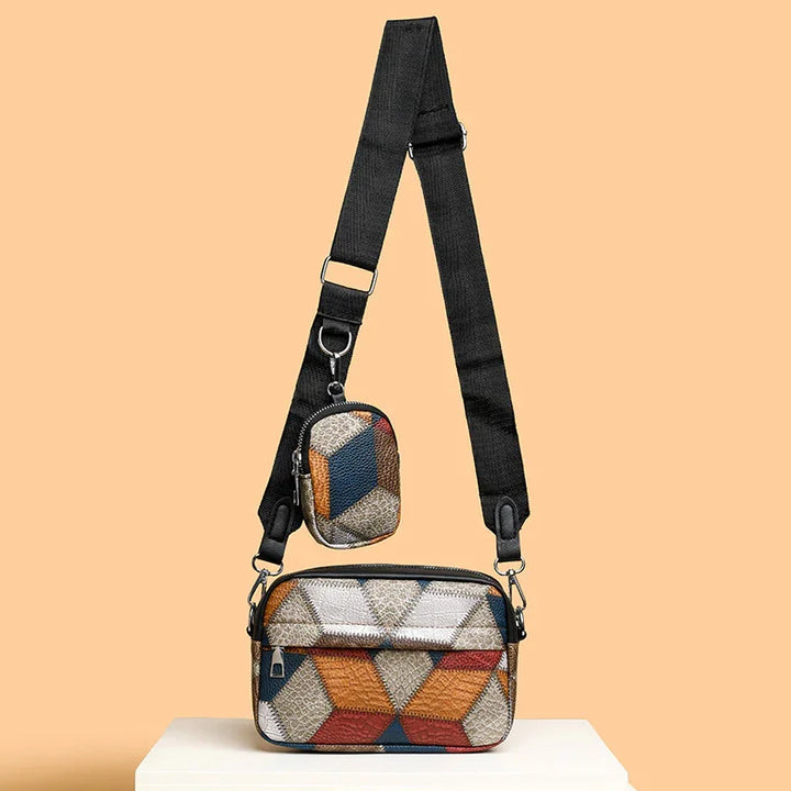 Adjustable black strap crossbody bag with geometric patterned main pouch and small pouch