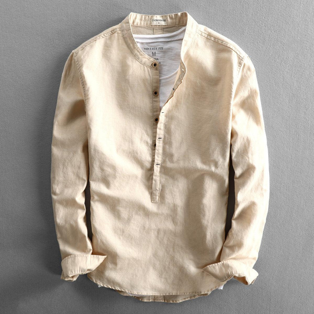 Beige long-sleeve men's vintage fit henley shirt with collarless neckline on gray background