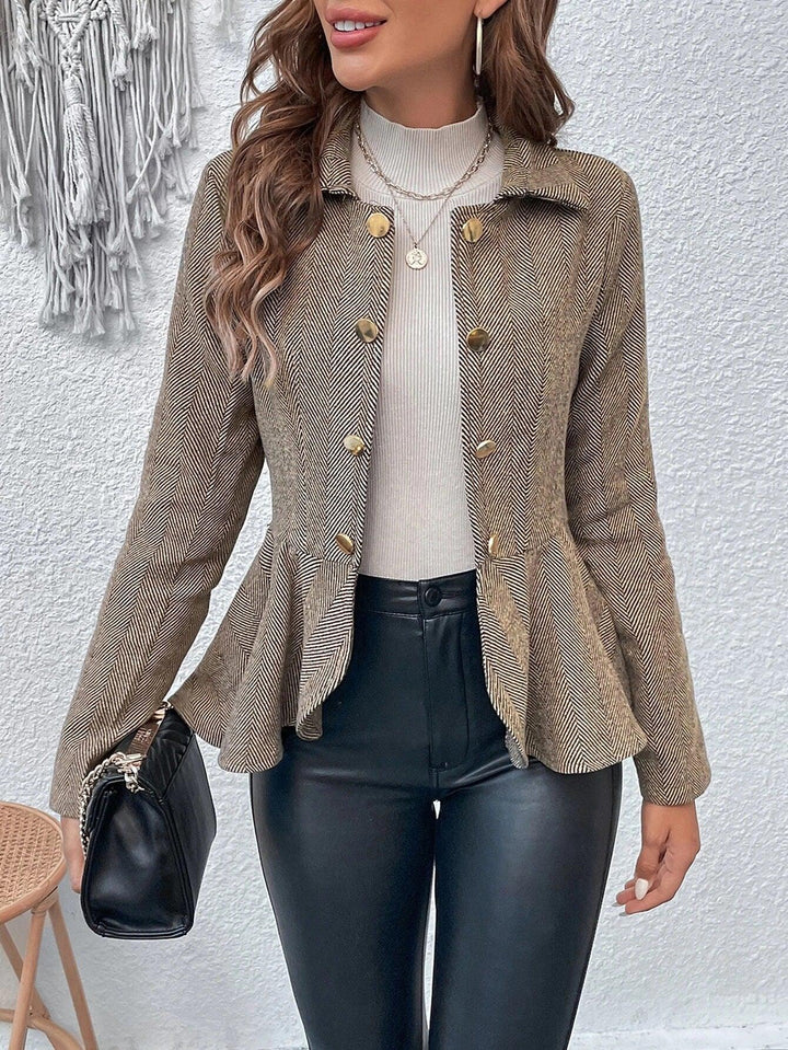 Woman wearing beige herringbone peplum blazer with gold buttons, cream ribbed top, black leather pants, holding black handbag
