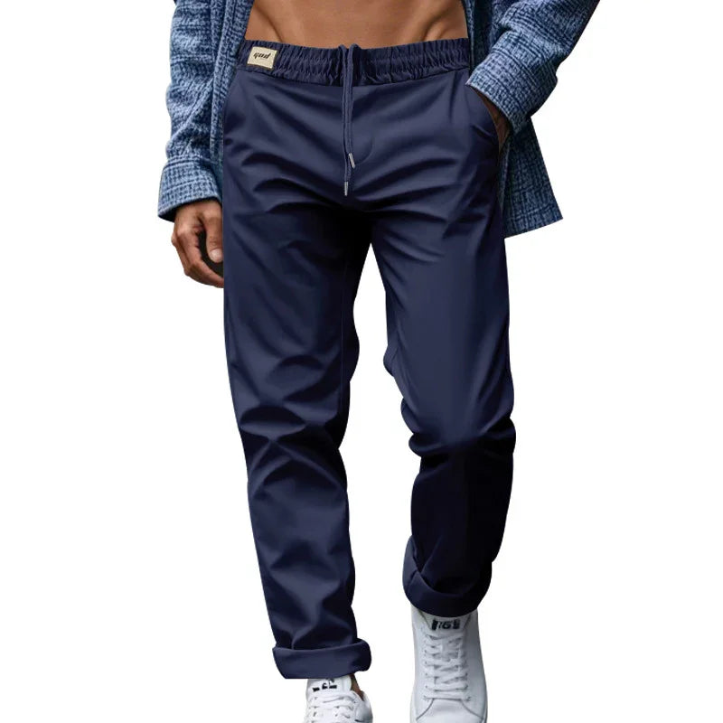 man wearing navy blue casual jogger pants with drawstring and white sneakers