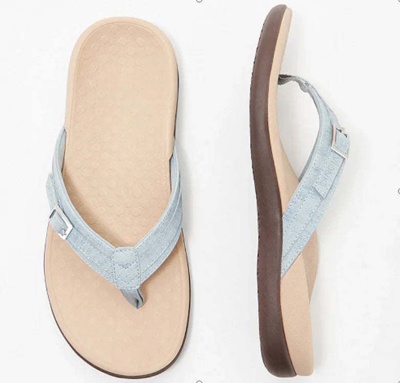 Light blue fabric strap flip-flop sandals with beige cushioned sole and dark brown outsole, top and side view