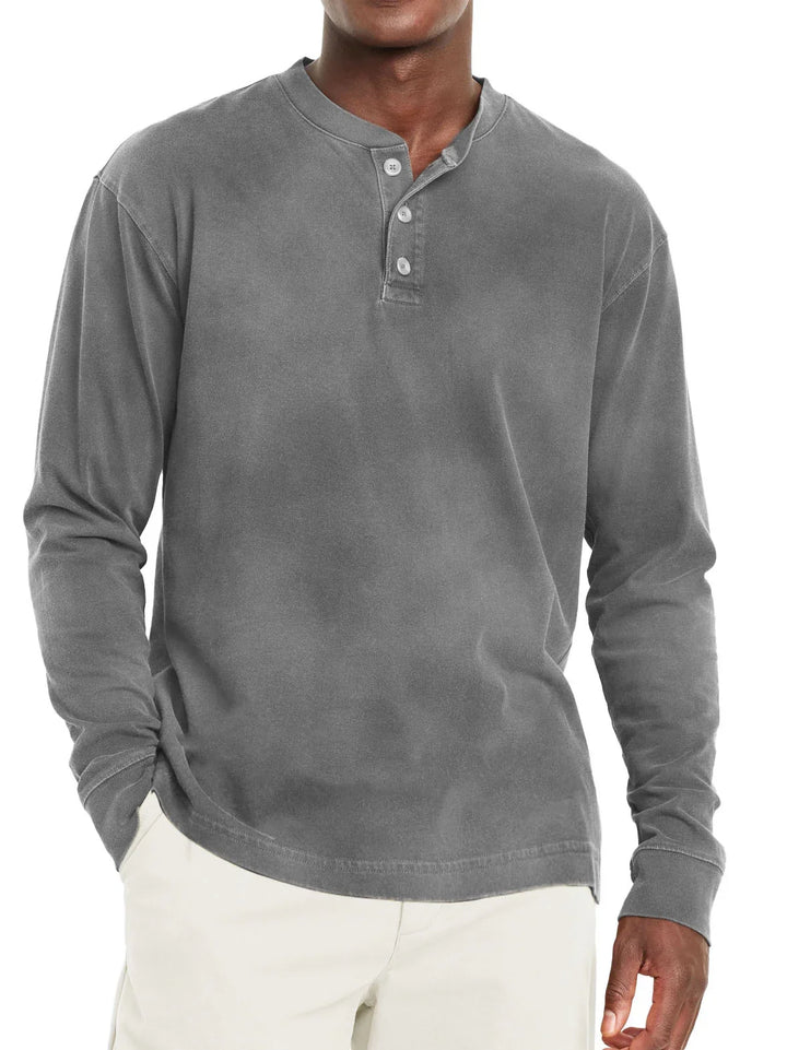 Man wearing gray long sleeve henley shirt with three buttons and beige pants
